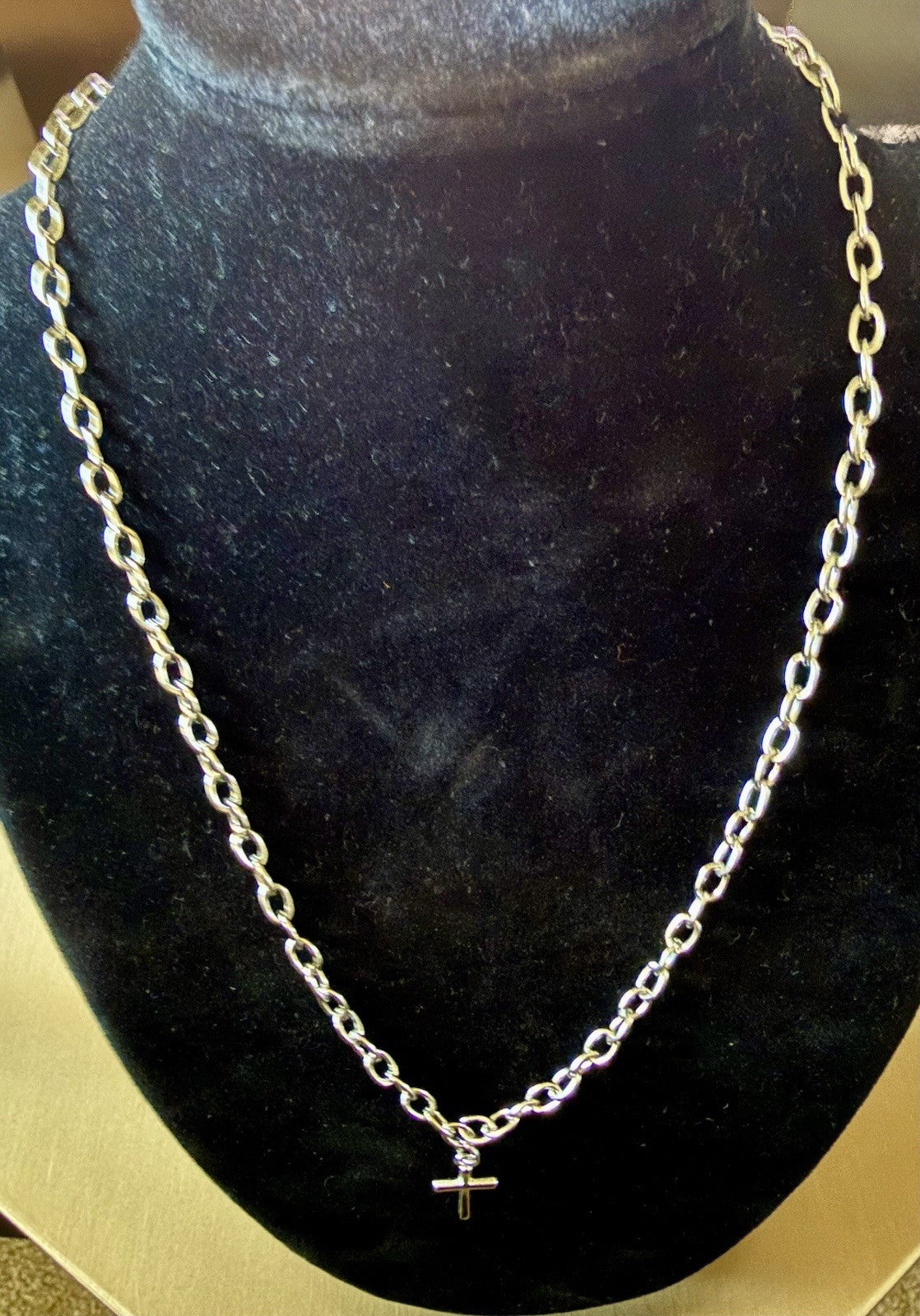 silver-tone chain necklace with a small cross pendant