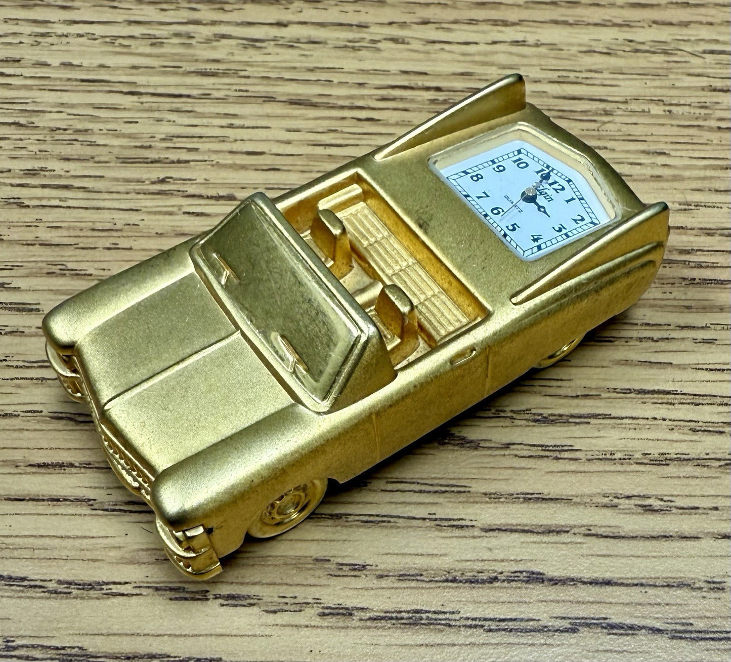 vintage Elgin miniature desk clock shaped like a gold-toned 1962 Cadillac