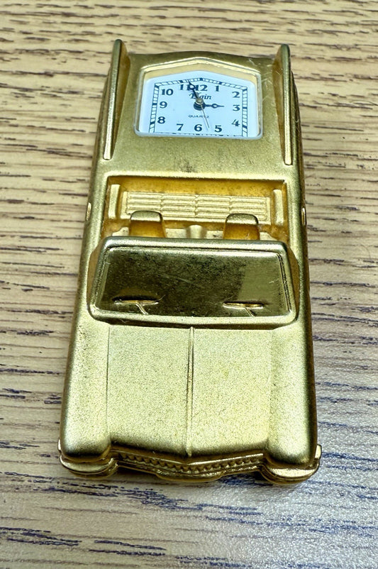 vintage Elgin miniature desk clock shaped like a gold-toned 1962 Cadillac