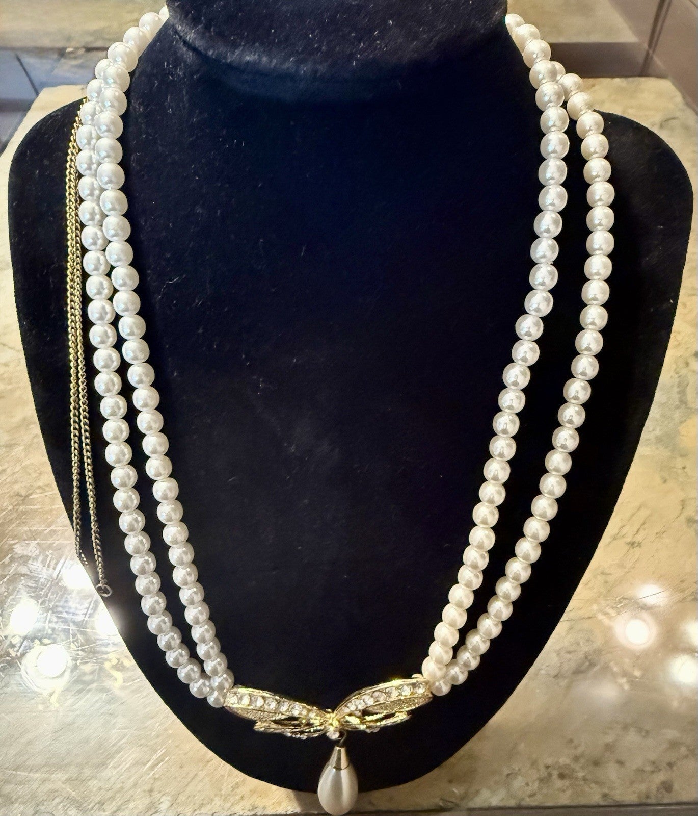vintage triple-strand faux pearl piece featuring a gold-tone butterfly