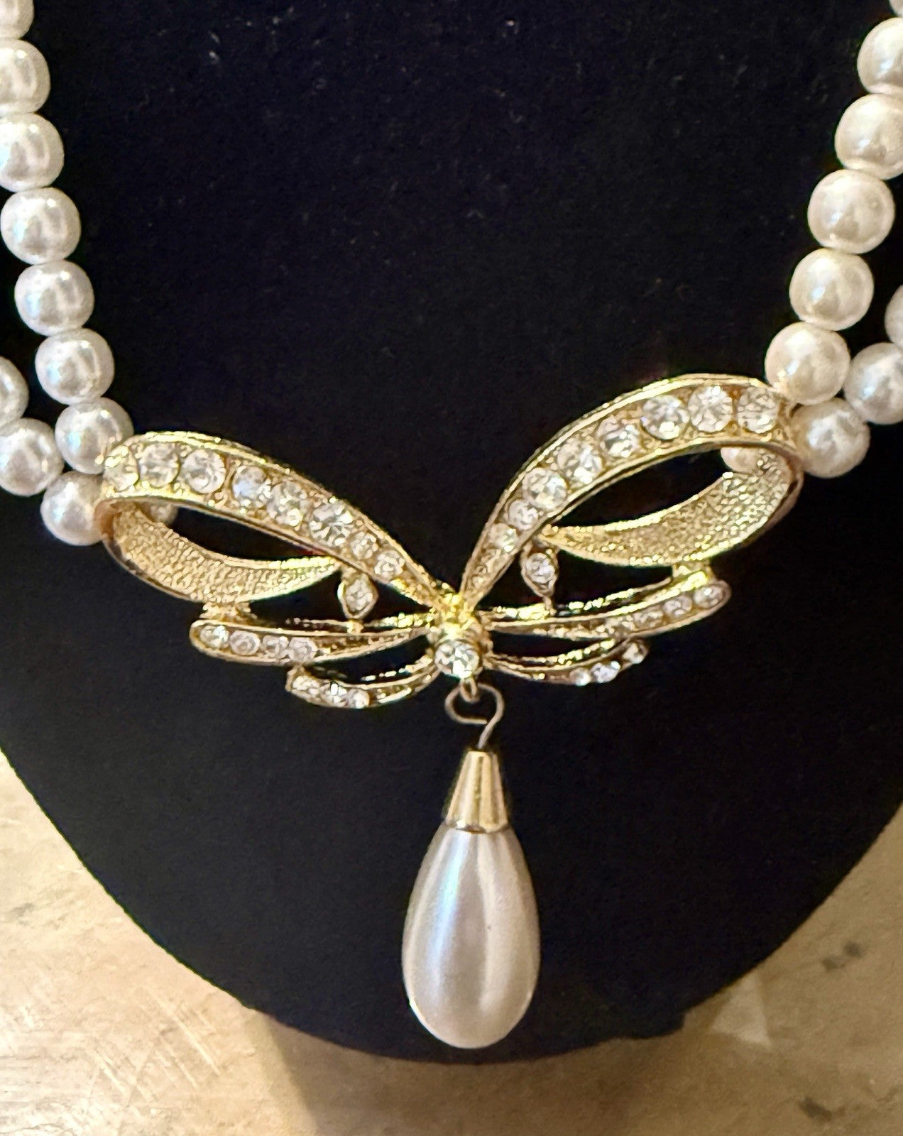 vintage triple-strand faux pearl piece featuring a gold-tone butterfly
