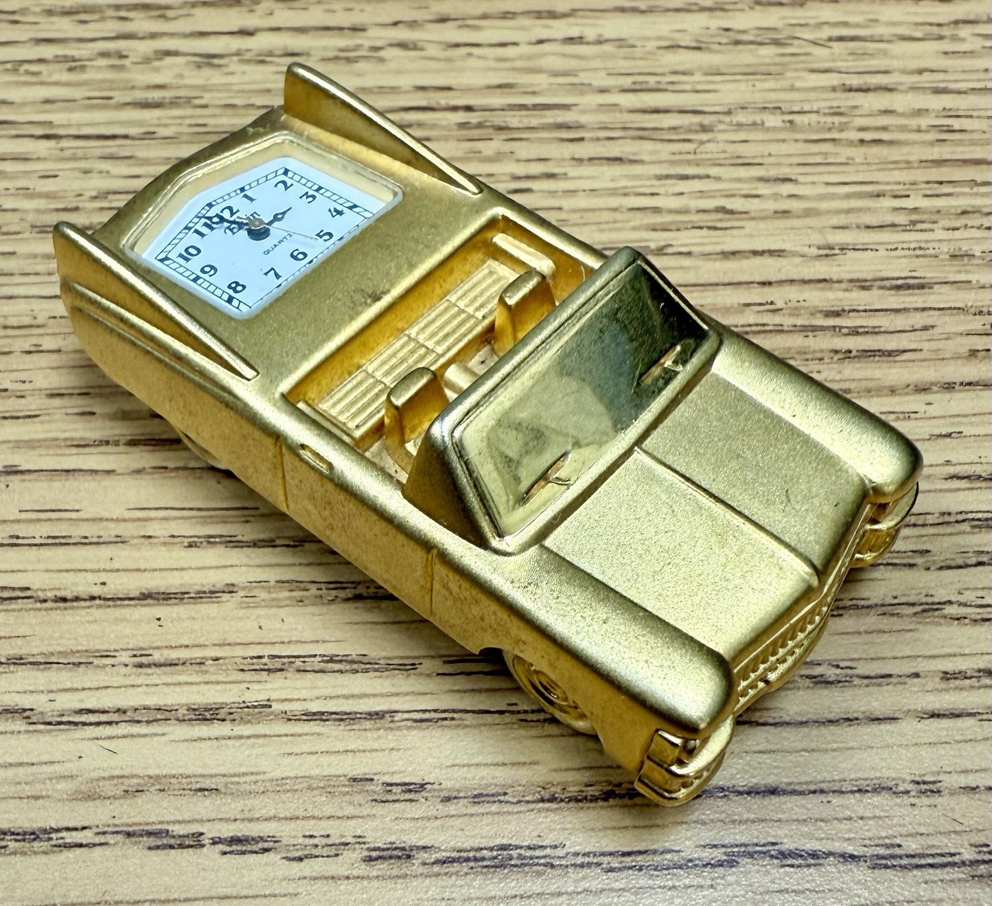 vintage Elgin miniature desk clock shaped like a gold-toned 1962 Cadillac