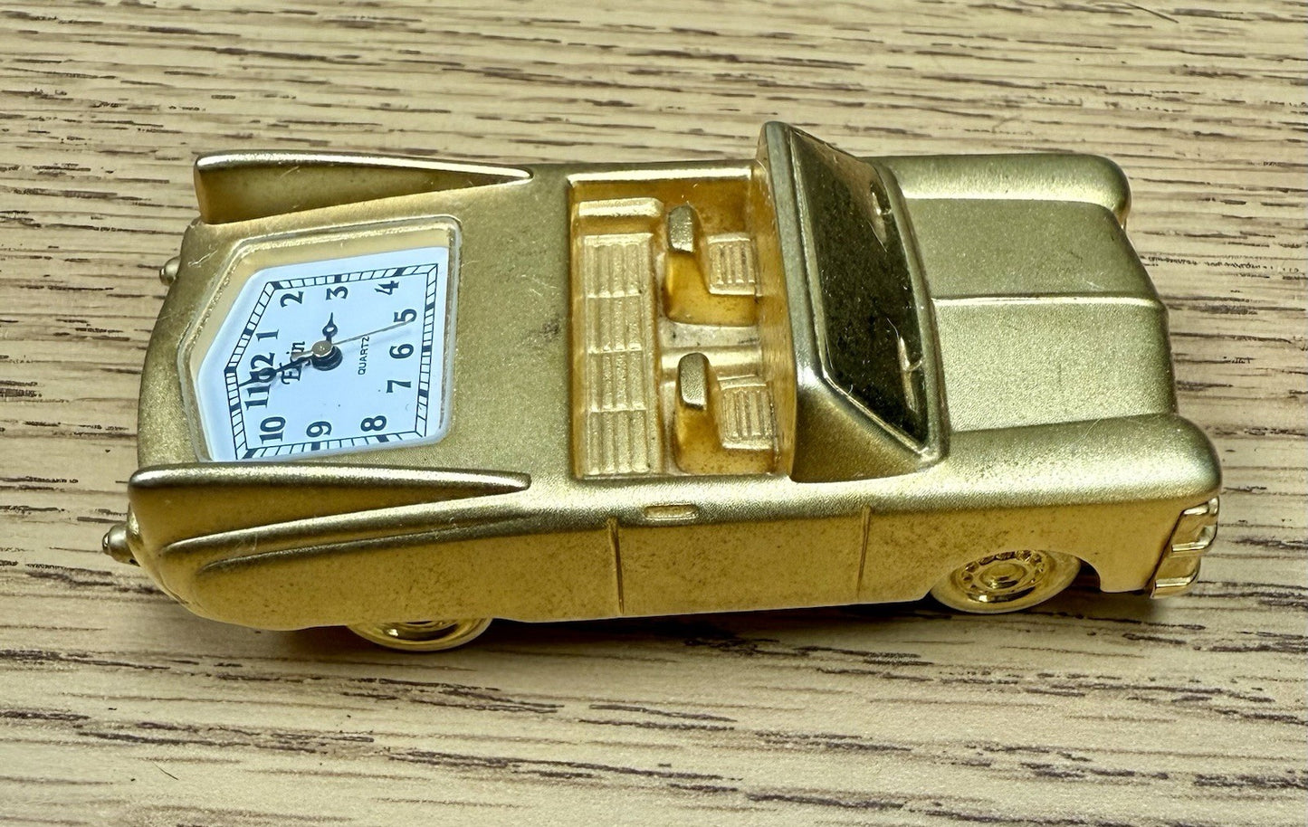 vintage Elgin miniature desk clock shaped like a gold-toned 1962 Cadillac