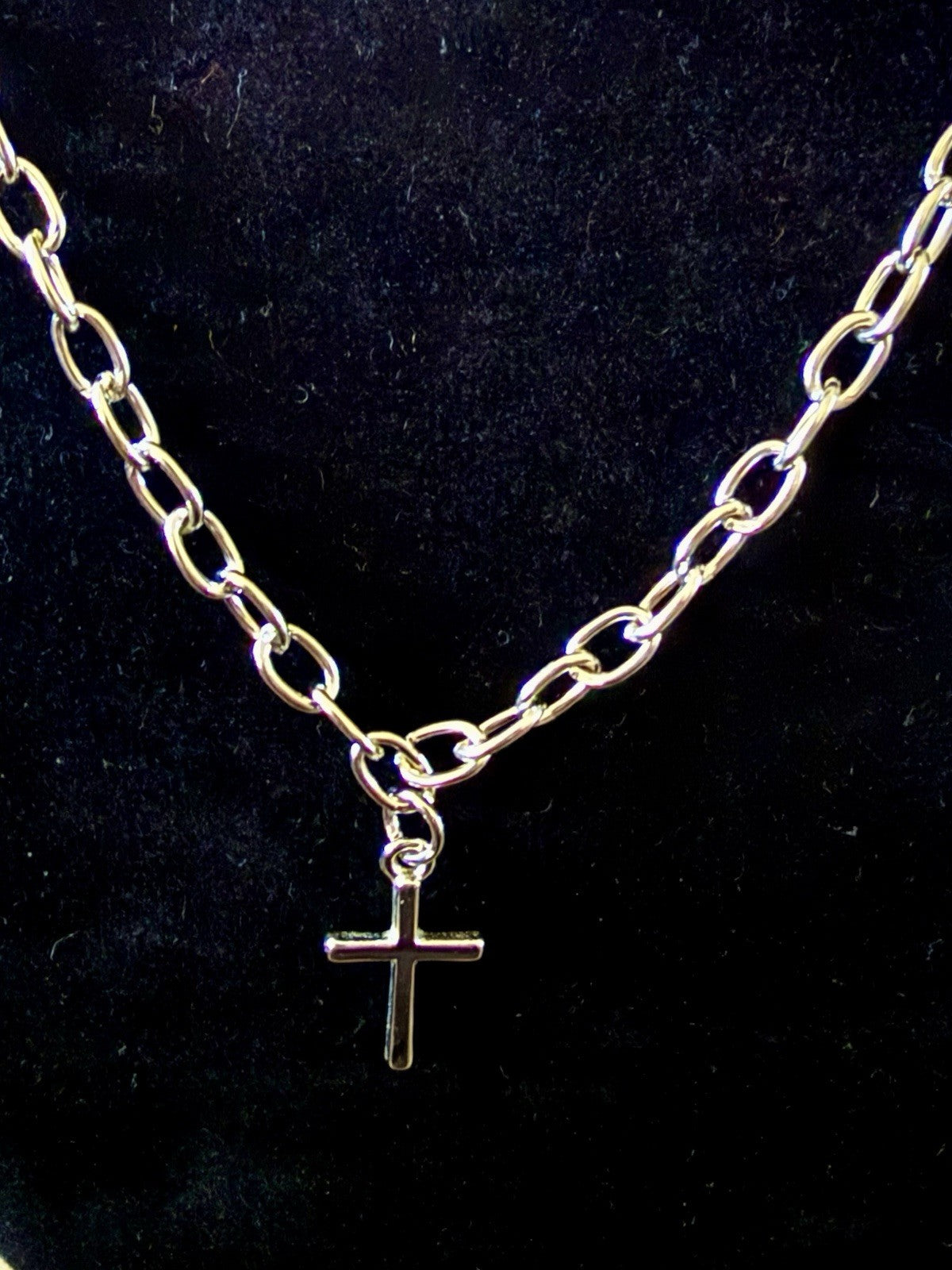 silver-tone chain necklace with a small cross pendant
