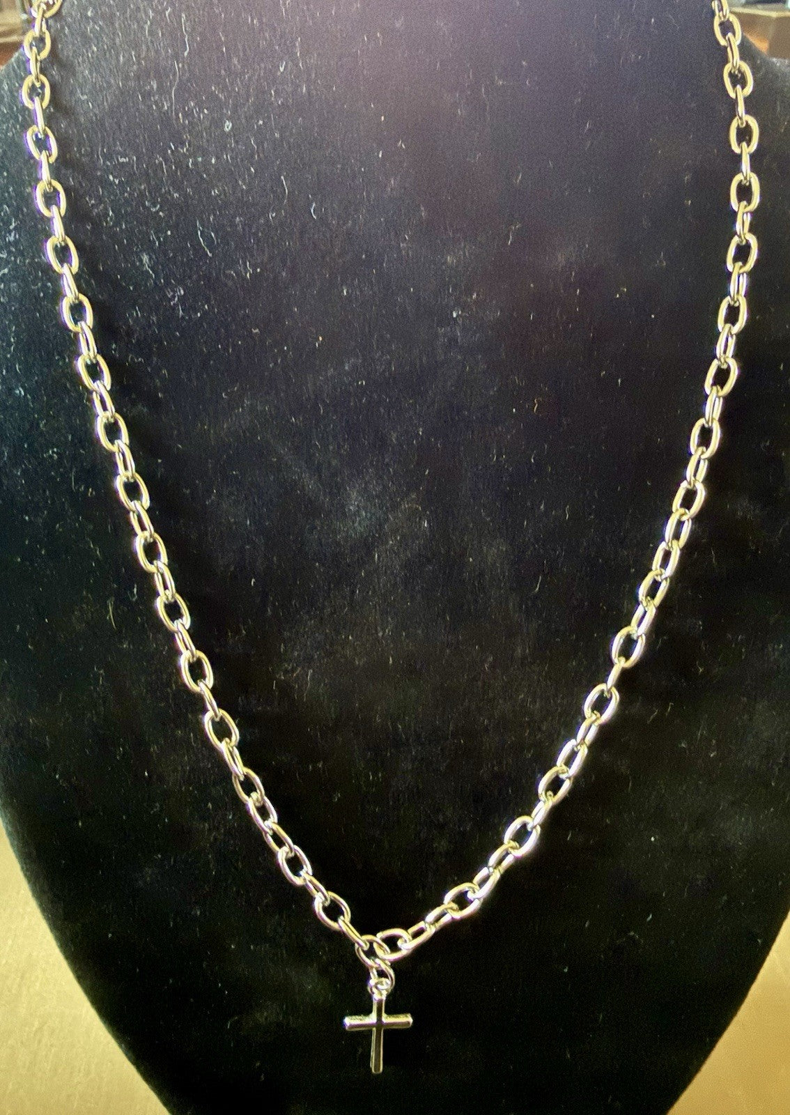 silver-tone chain necklace with a small cross pendant